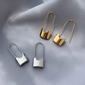 Minimalist padlock shaped hoop earrings in polished gold and silver metal finishes