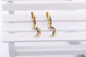 Close-up of golden moon earrings featuring vibrant multicolor micro-set cubic zirconia