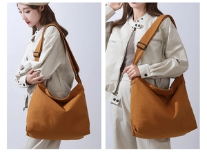 Dettaglio di una grande borsa a tracolla in tela di cotone marrone dal design retrò semplice