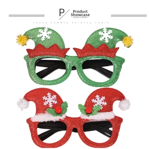 Detailed view of sequined Christmas glasses with elk antlers and Santa hats for parties