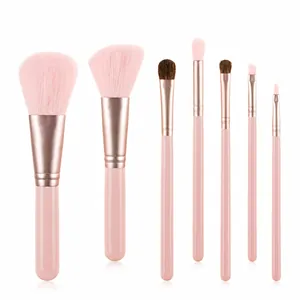 Close-up of 7-piece mini makeup brush set with pink handles and rose gold ferrules