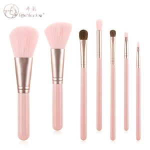 Close-up of 7-piece mini makeup brush set with pink handles and rose gold ferrules