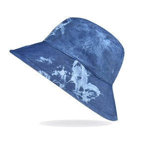 Detail of wide brim tie-dye bucket hat in navy and light blue cotton denim material