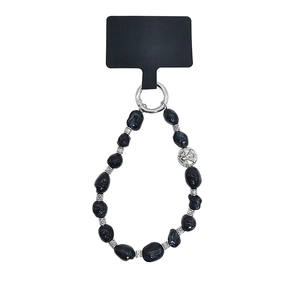 Detailed macro of black beaded phone strap with St. Benedict silver pendant and card