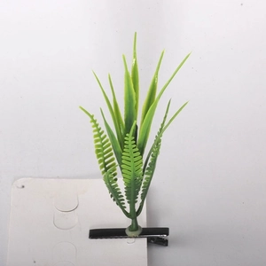 Detailed view of a creative green plant hair clip with a black metal duckbill clip