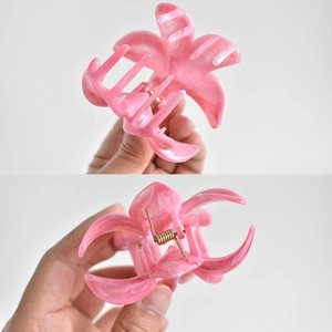 Close-up of pink marble flower hair claw clip with a strong gold metal spring mechanism