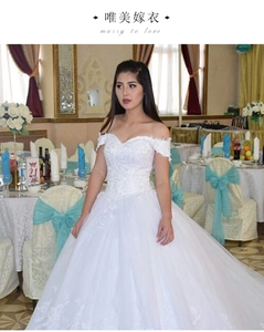 Detailed embroidery and delicate lace on an elegant white off-shoulder bridal wedding gown