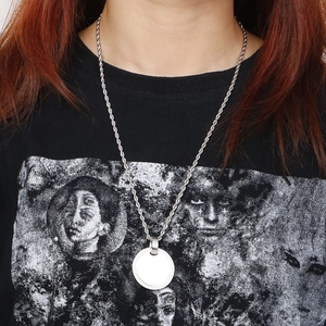 Silver twist chain necklace with minimalist round disc pendant worn by a model