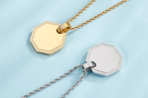 Macro view of gold and silver octagon pendants with sparkling pavé crystals on a rope chain
