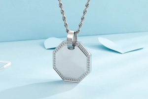 Macro detail of silver octagonal titanium steel pendant with shimmering zircon pavé border