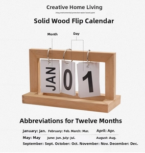 Close-up of wooden perpetual flip calendar with metal rings and minimalist white cards