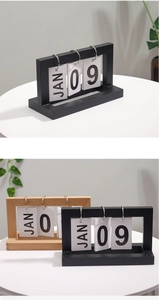 Detail of wooden flip perpetual calendar showing black and natural wood styles with metal rings