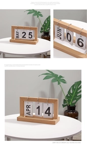 Macro detail of Nordic wooden flip calendar with metal rings and white date cards