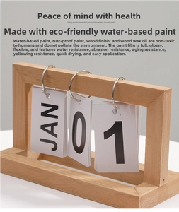 Detail view of the wooden desktop flip calendar with metal rings and paper date cards