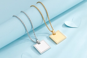 Close-up of square zircon pendants in gold and silver finish with twisted rope chains