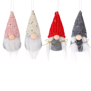 Set of four knitted sequin Christmas gnomes in pink, beige, red and grey for decoration