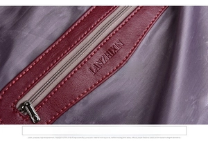 Detail showing the inner zipper pocket with high-quality purple lining and soft leather trim