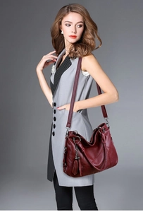 Elegant burgundy large capacity leather shoulder bag with decorative tassel detail