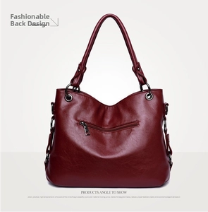 Back view of burgundy tote bag featuring leather texture and secure zipper pocket