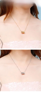Close-up of gold and silver cylinder pendants with pavé crystals on waist-shaped necklaces