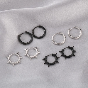 Detailed view of silver and black Mobius earrings with twist and stud textures