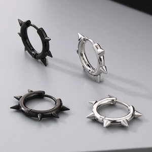 Close-up of punk style stainless steel spike hoop earrings in black and silver finishes