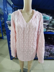 Close-up of pink cable knit texture on long sleeve hooded sweater with V-neckline