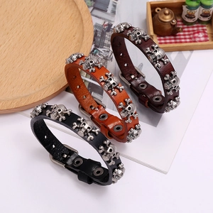 Three punk skull leather bracelets in black and brown with adjustable metal buckle closures