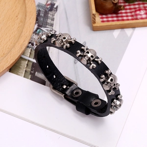 Detail of a punk skull leather bracelet with adjustable metal buckle and vintage studs