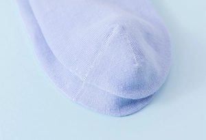 Macro shot of purple combed cotton socks showing fine knit texture on the toe part