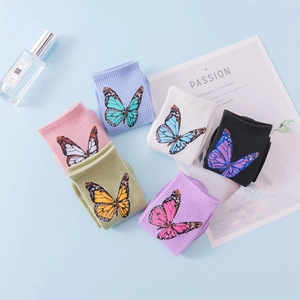 Flat lay of six colorful cotton blend butterfly socks including pastel pink and blue