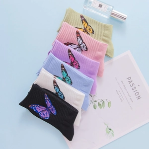 Detail of six-color combed cotton socks with butterfly embroidery and ribbed cuffs