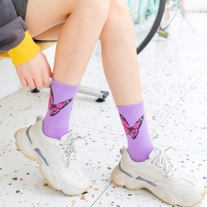 Detailed view of purple combed cotton socks featuring a pink butterfly pattern design