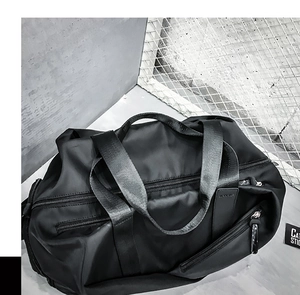 Macro detail of high-density nylon fabric and reinforced zipper on black sports travel bag