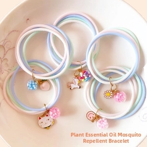 Macro shot of macaron-colored mosquito repellent bracelets with cute cartoon charms