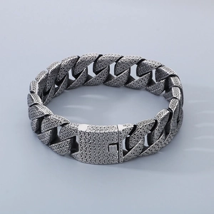 Retro stainless steel Cuban link bracelet with intricate scale texture and pin buckle