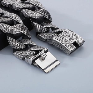 Vintage oxidized silver Cuban link chain bracelet with relief patterns and plug buckle