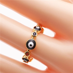 Bohemian gold evil eye ring with colorful enamel patterns and zircon stones on a hand