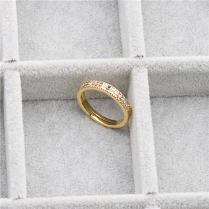 Adjustable gold ring with micro-pave multicolored zircon stones on gray velvet tray