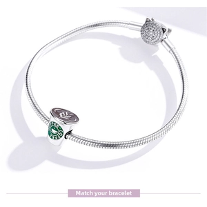 Macro detail of S925 silver bracelet featuring enamel coffee cup and crystal cat charms