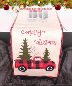 Detail of linen Christmas table runner featuring red truck and buffalo plaid edges