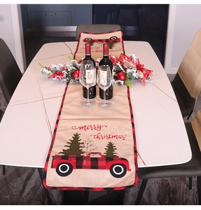 Linen Christmas table runner with red truck and tree, featuring Merry Christmas text