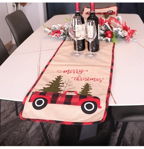 Christmas table runner with red truck, pine tree, and red black plaid borders