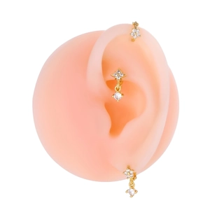 Detailed view of three gold ear cuffs with micro-pave zircons on pink silicone ear model