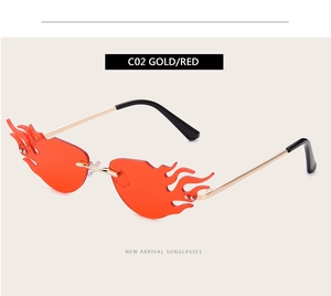 Detail view of flame-shaped rimless sunglasses with gold temples and red gradient lenses