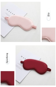 Detail of silk sleep mask elastic strap and premium satin texture in pink and wine red