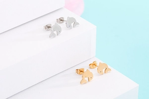 Detailed view of fashionable dolphin-shaped stud earrings in silver and gold finishes