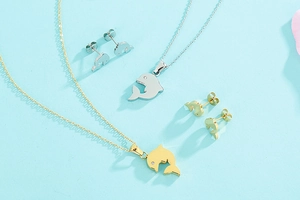 Macro shot of stylish dolphin necklace and stud earrings set with sparkling stones