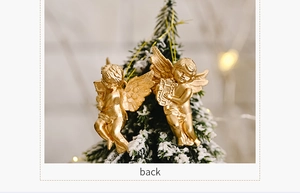 Detailed view of two gold angel ornaments hanging on a snowy Christmas tree