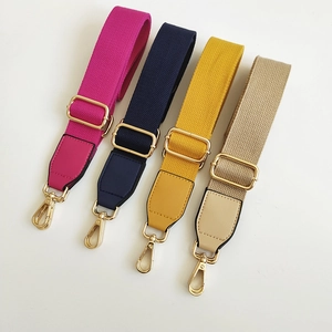 Close-up of colorful canvas bag straps with premium gold metal hardware and PU leather ends